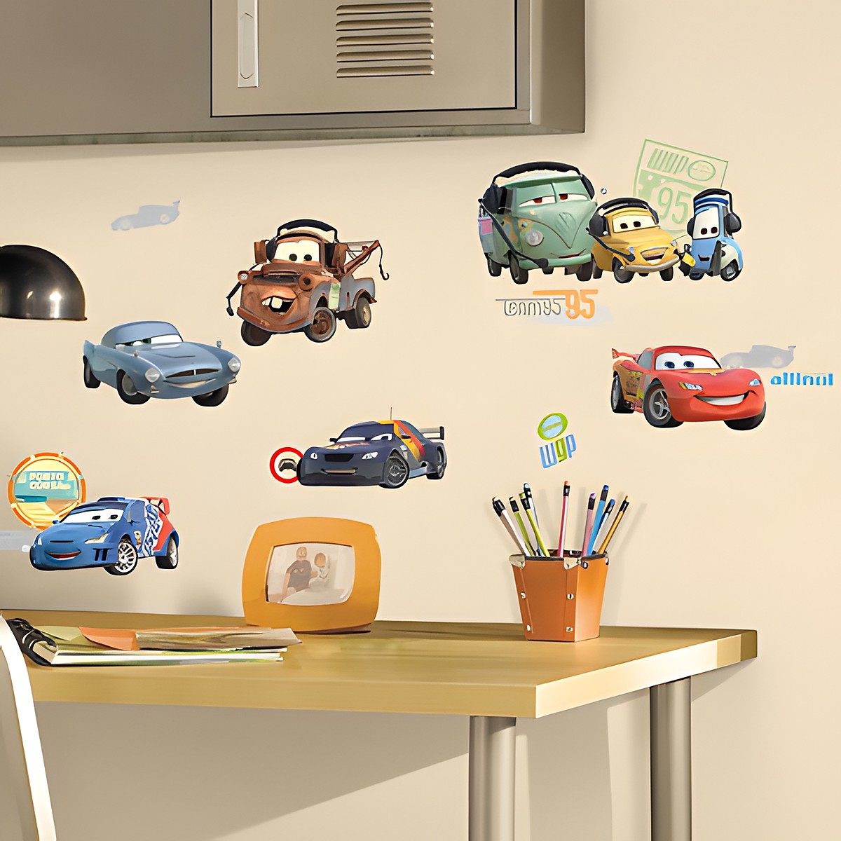 RoomMates wall decal Disney Pixar Cars, Lightning McQueen, Mater and other Cars characters on a cream-coloured children's room wall above a desk