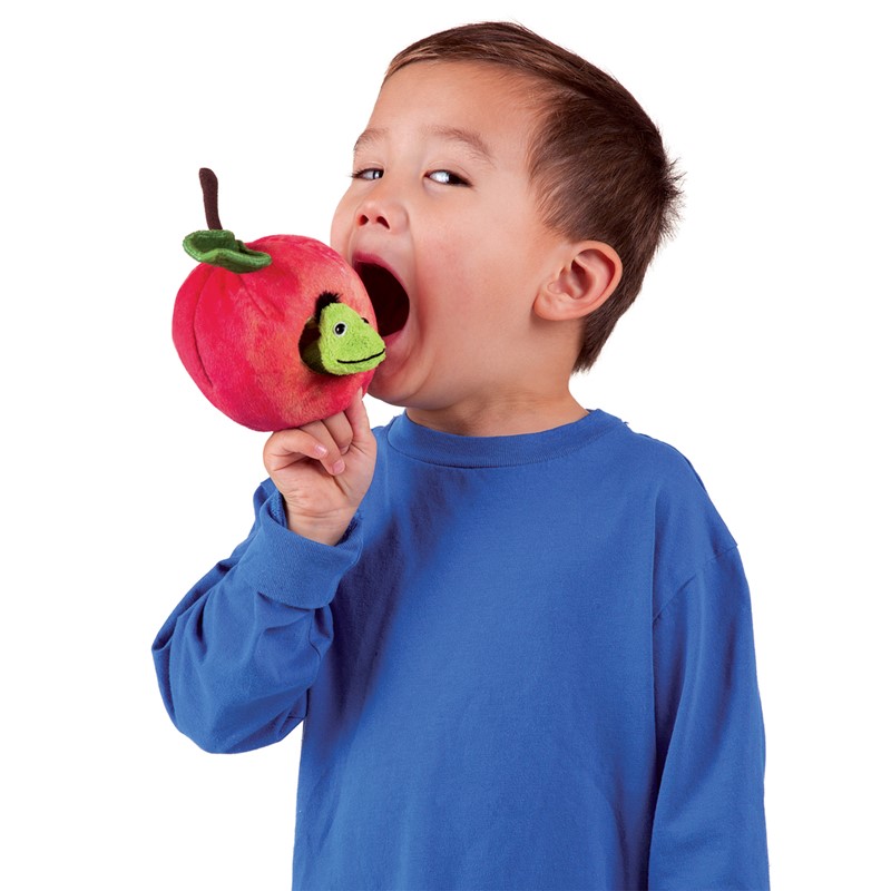 Boy holding the Folkmanis red plush apple finger puppet with a green worm finger puppet head up to his mouth