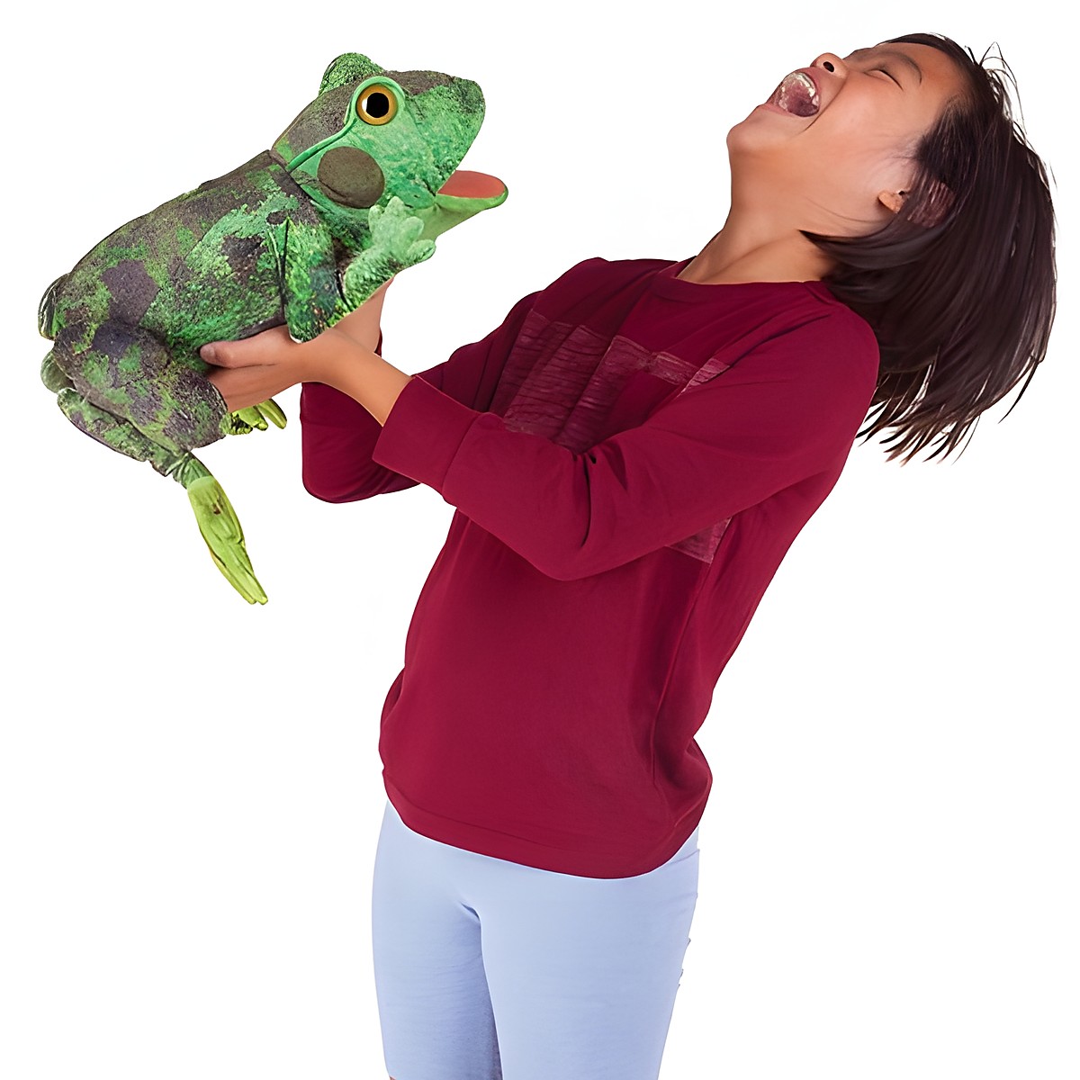 Laughing child holding the Folkmanis green frog metamorphosis hand puppet with its tongue sticking out up in the air