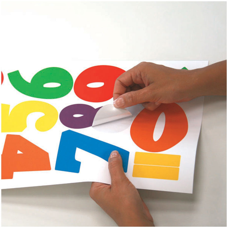 RoomMates wall decal Colourful Numbers, hands peeling colourful numbers off the backing sheet, usage example