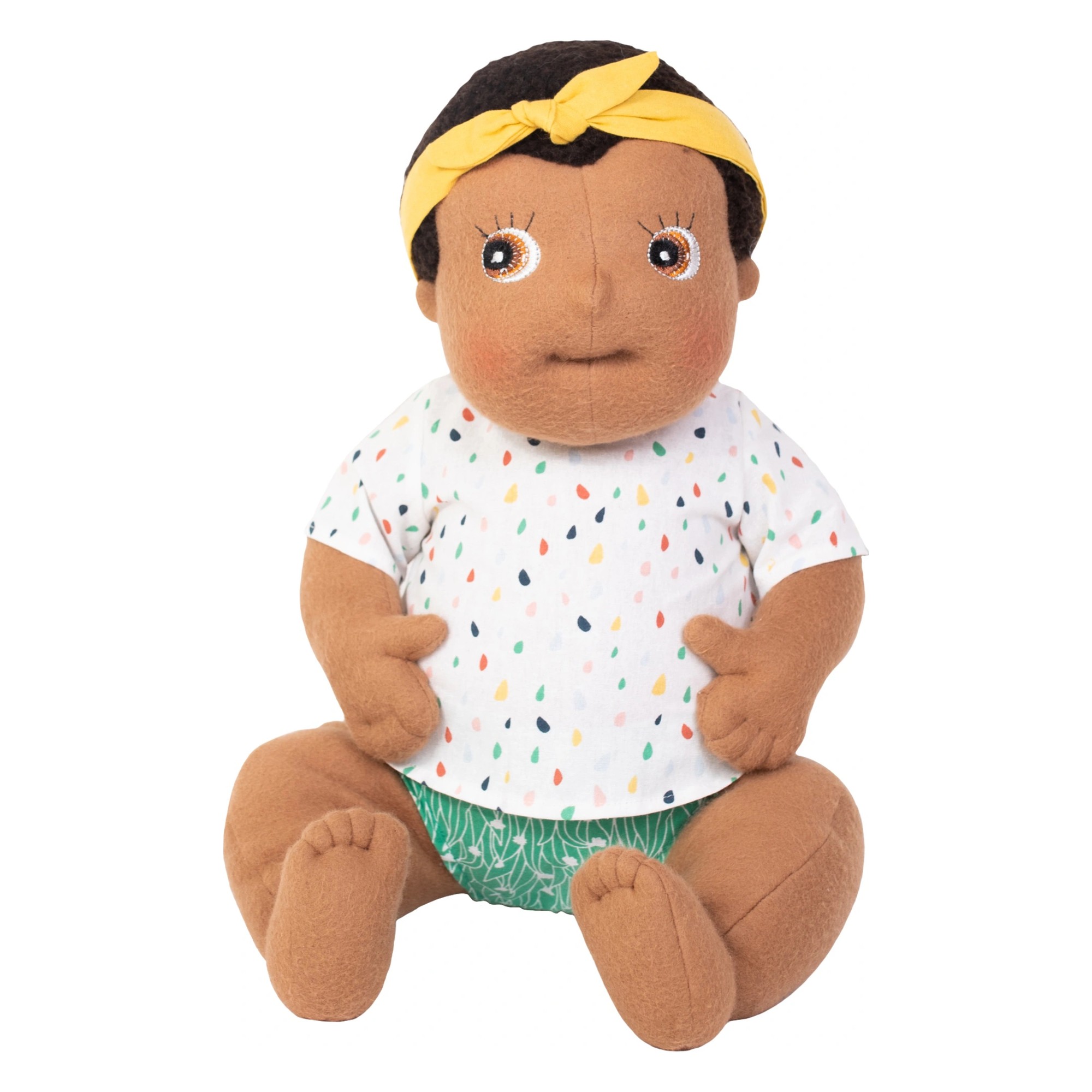 Rubens Barn baby doll Flo with yellow headband, dotted shirt and green nappy pants, sitting