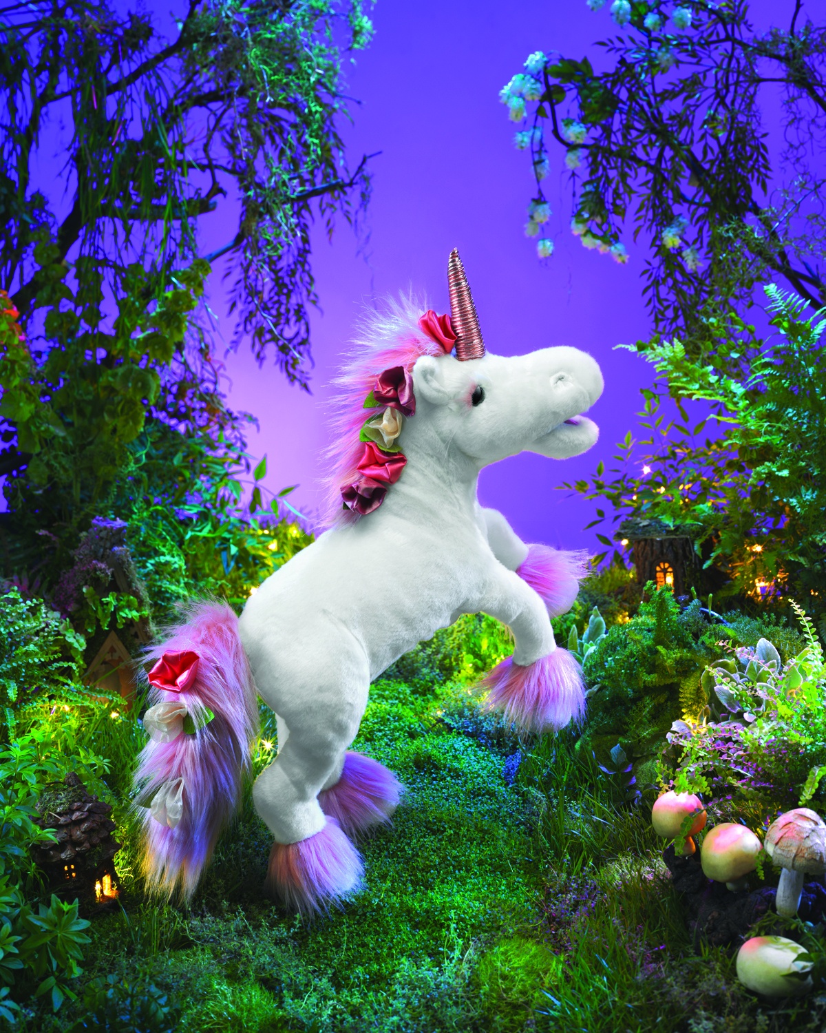 Folkmanis unicorn hand puppet in white with pink fur on the mane and hooves, a copper-coloured horn and silk flowers, posed rearing up