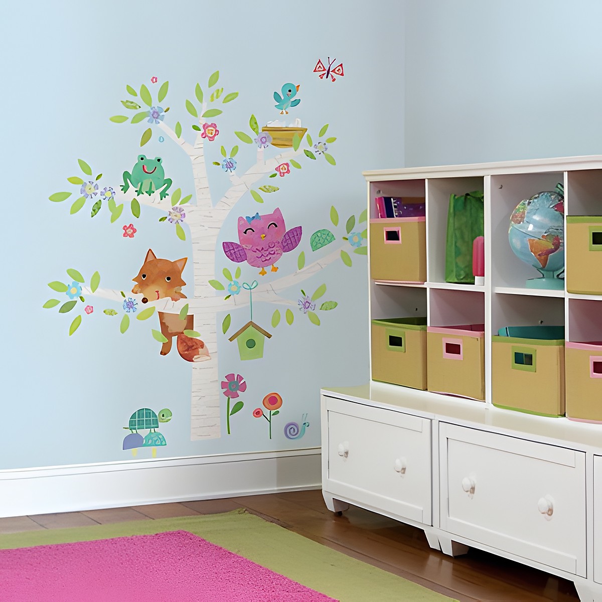 RoomMates wall decal Woodland Baby Animals Tree, birch tree with a fox, owl, frog and birdhouse on a light blue children's room wall next to a shelf