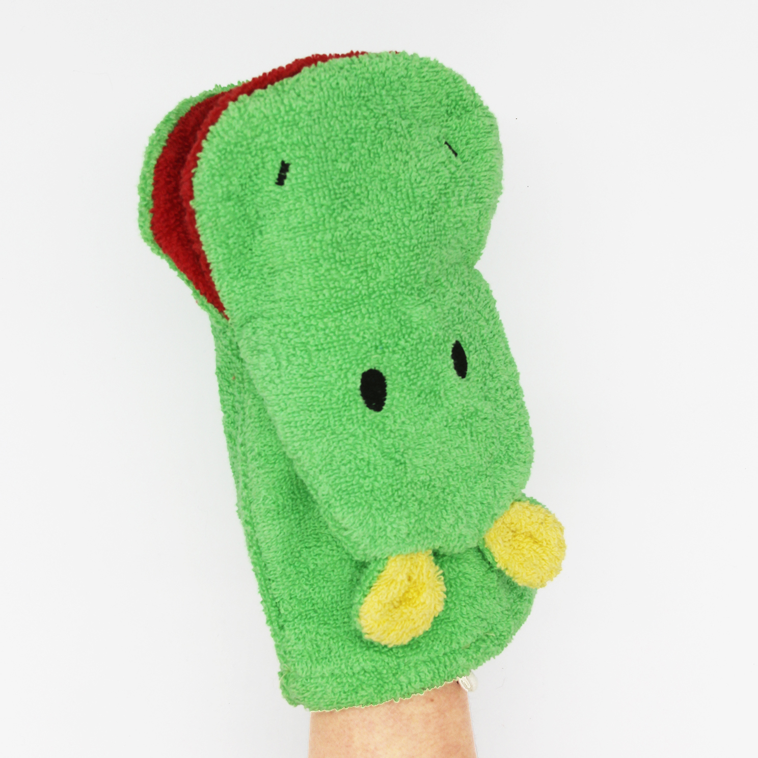 Fürnis organic washcloth hippo Norbert worn as mitt on arm, yellow ears at bottom, red trim at top