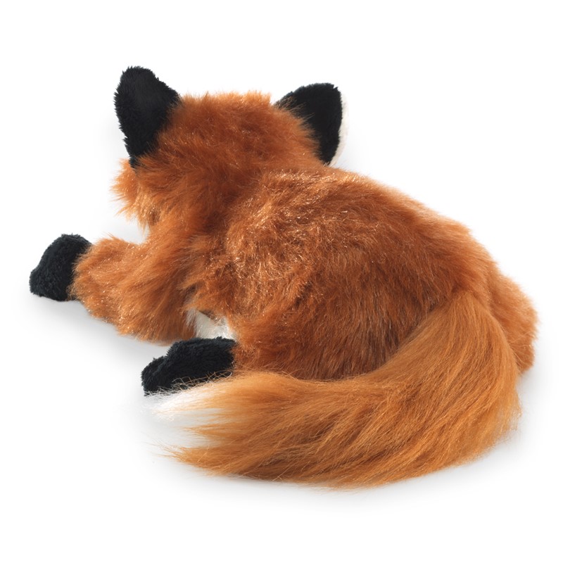 Folkmanis Handpuppe kleiner Rotfuchs in zusammengerollter Schlafpose, rotbraunes Langflor-Plüsch mit schwarzen Pfoten und buschigem Schwanz, Schrägansicht von oben.