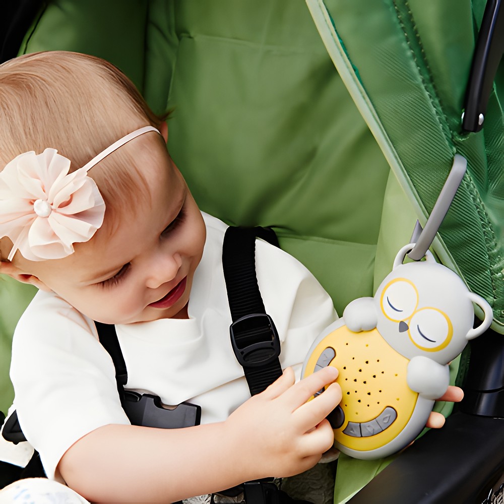 Cloud b Einschlafhilfe Sweet Dreamz on the Go Eule, Anwendungsfoto: Baby im Kinderwagen berührt das Gerät