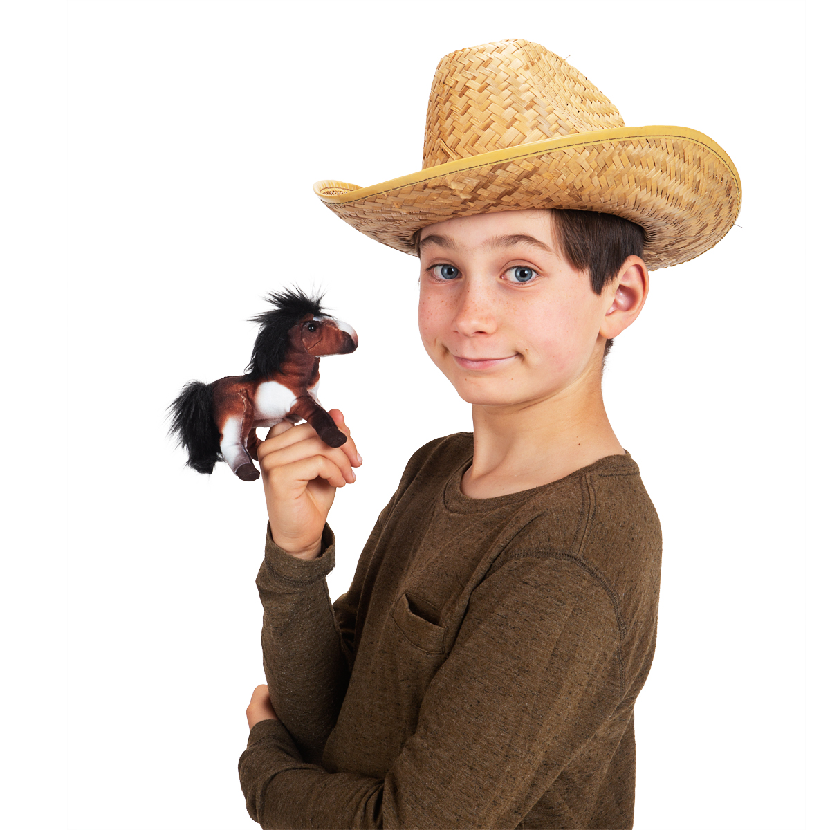 Boy wearing a straw hat holds a small Folkmanis mini paint horse finger puppet in brown with a black mane on his index finger
