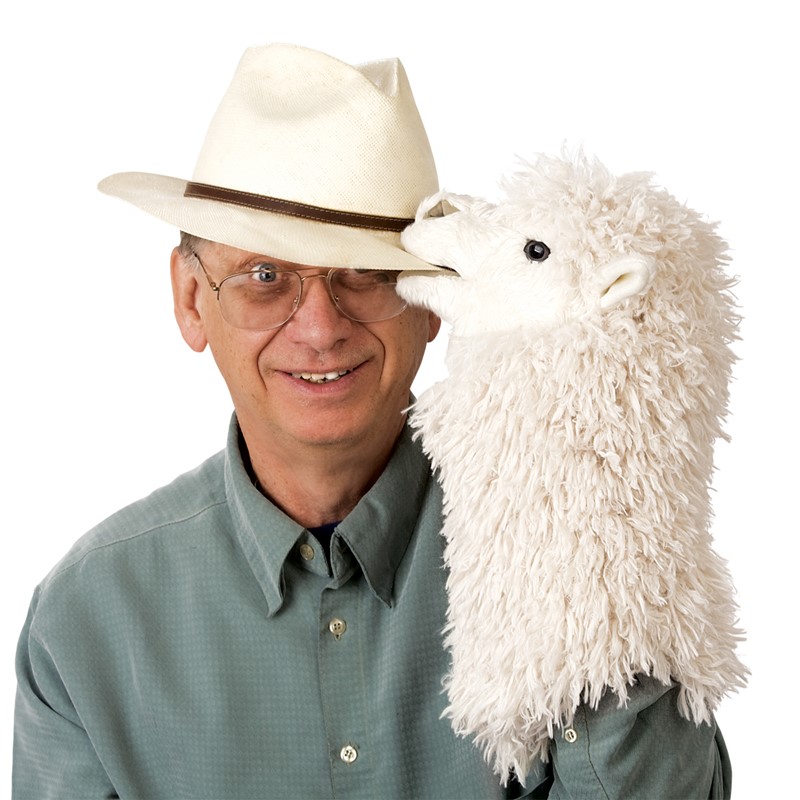 Folkmanis alpaca hand puppet with white shaggy fur playfully biting the Panama hat of a smiling man