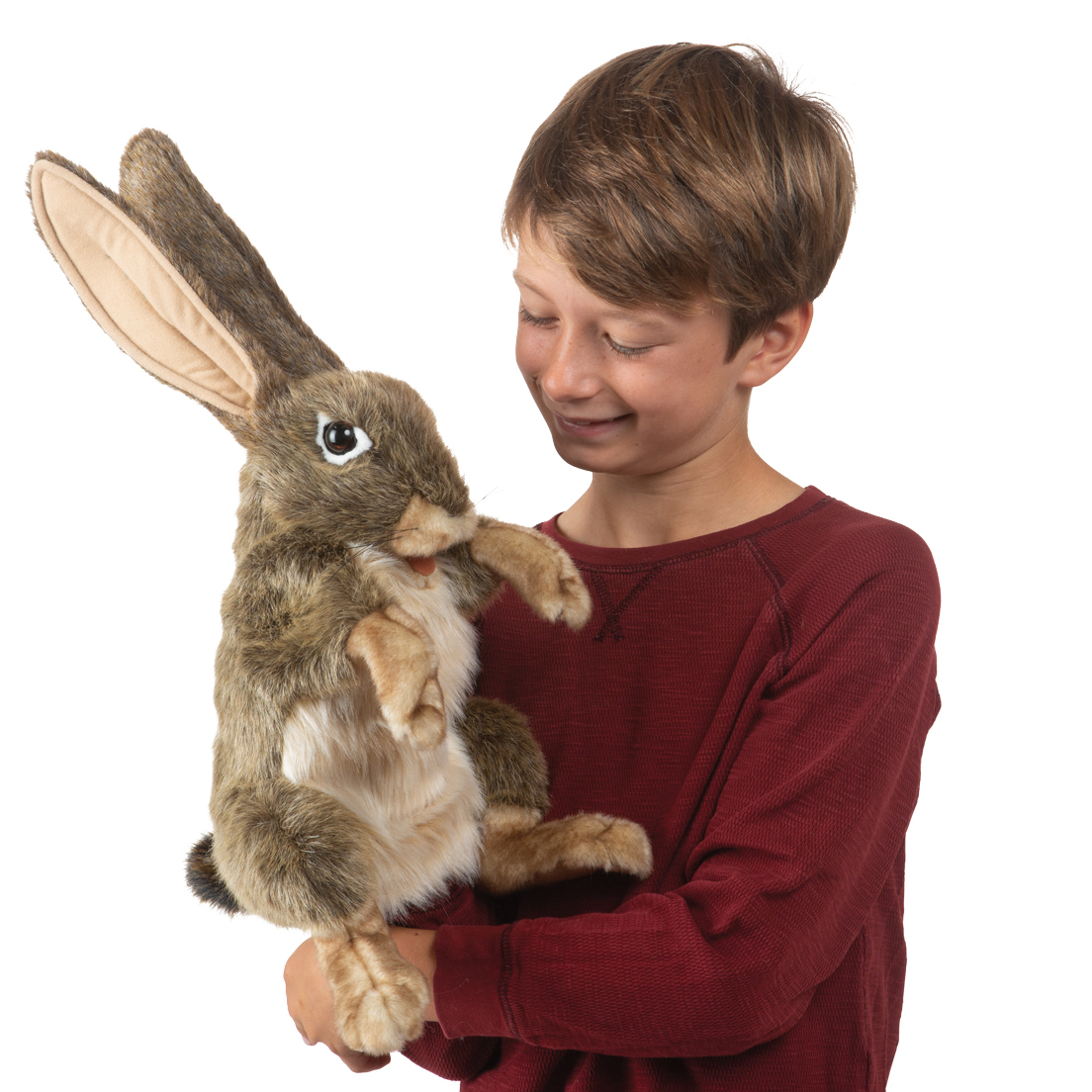Boy holding the Folkmanis jack rabbit hand puppet with brown fur, light belly and long ears in his arms