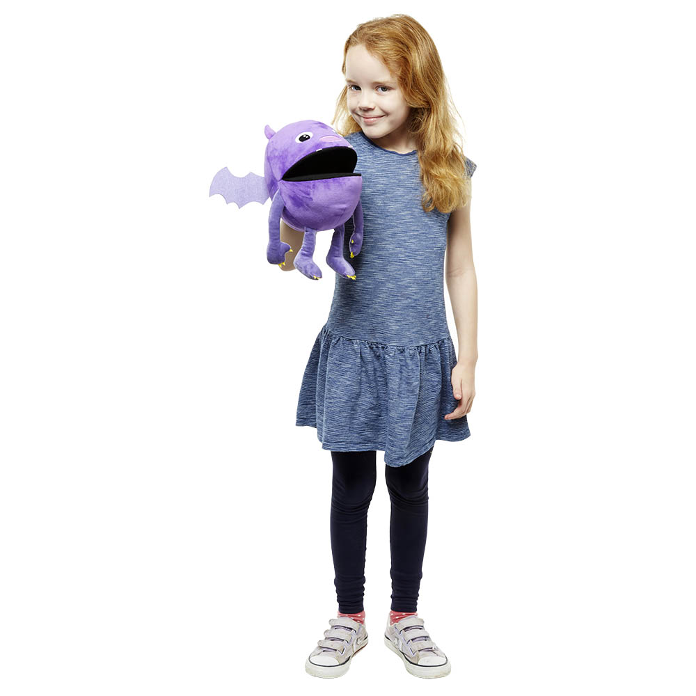 Girl presenting the The Puppet Company purple baby monster hand puppet, usage example facing the camera