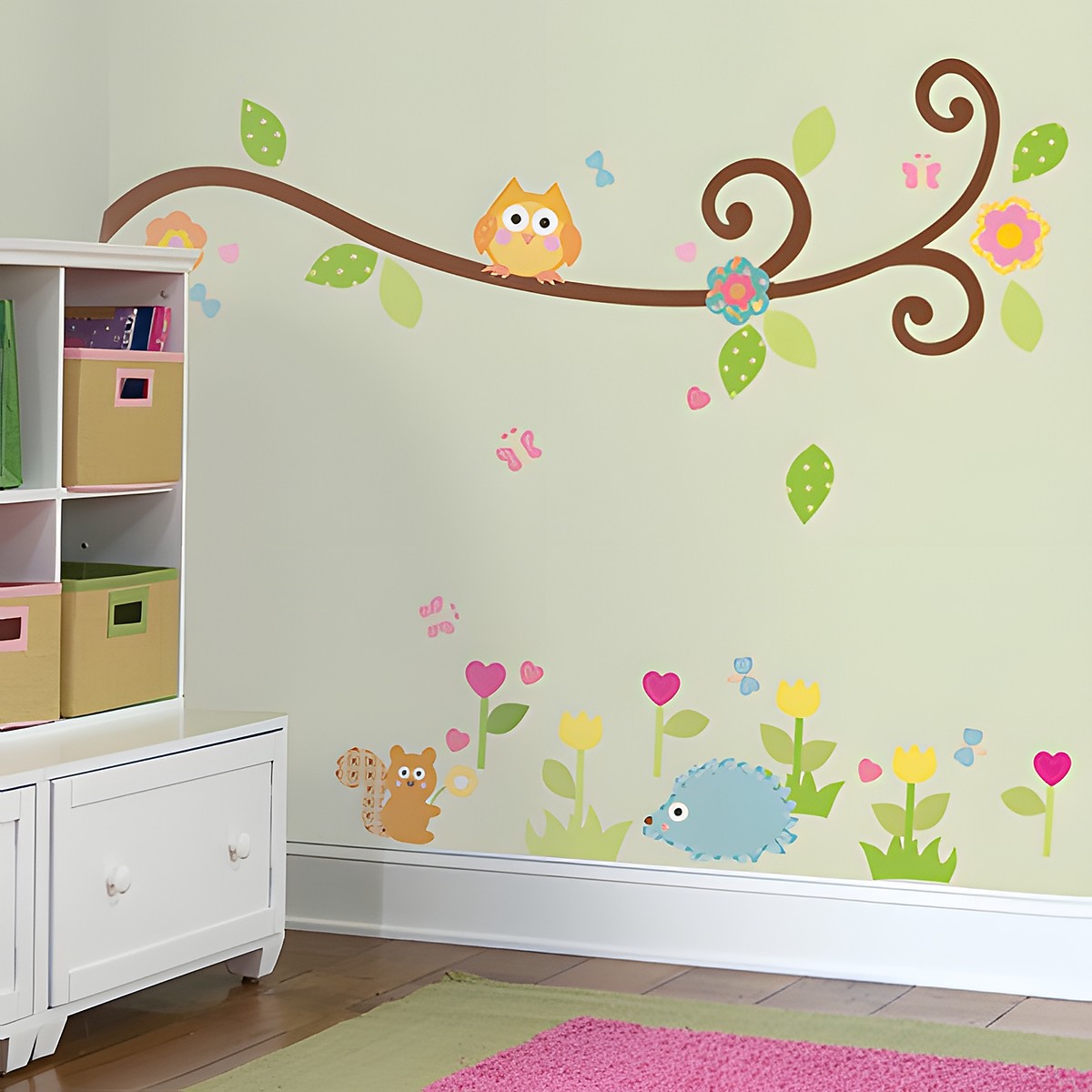 RoomMates wall decal Happi Scroll Branch, curved branch with an owl, blossoms and leaves above hedgehog and squirrel motifs on a green children's room wall
