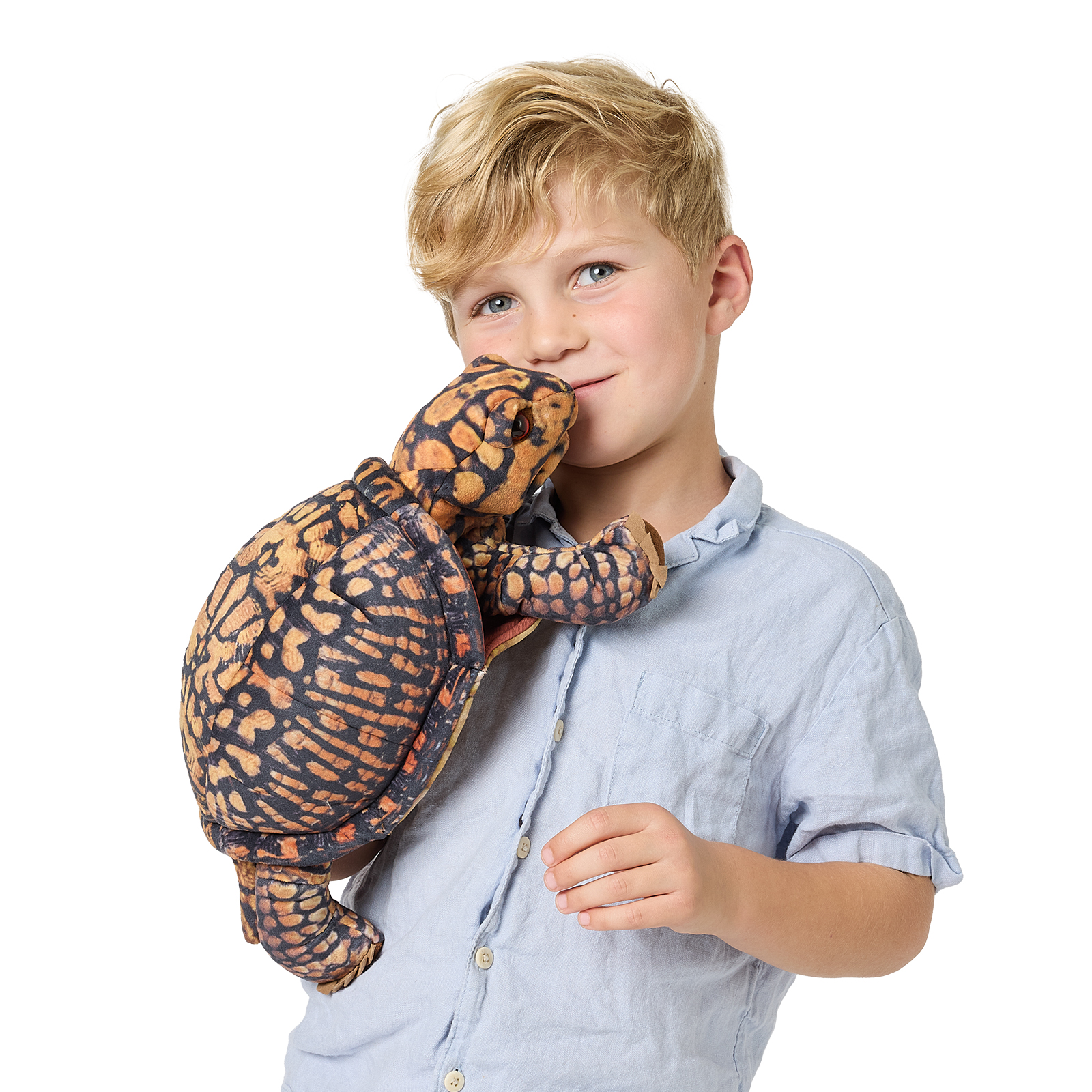 Boy holding a Folkmanis box turtle hand puppet with a dark orange scale pattern close to his face