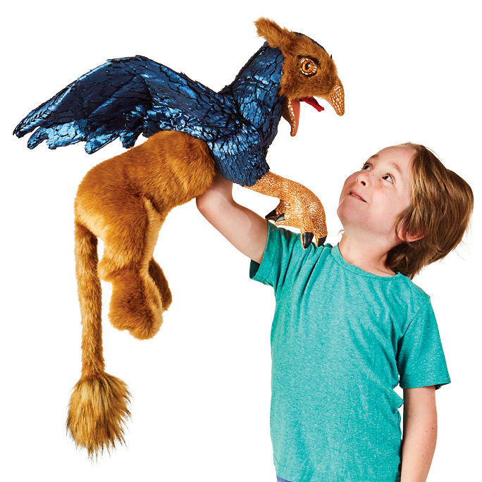 Folkmanis griffin hand puppet with blue plumage and reddish-brown fur, held up high by a child