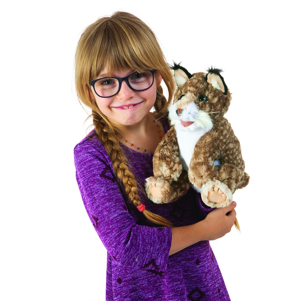 Girl with braids holding the Folkmanis bobcat kitten hand puppet with brown-patterned fur and black ear tufts in her arms
