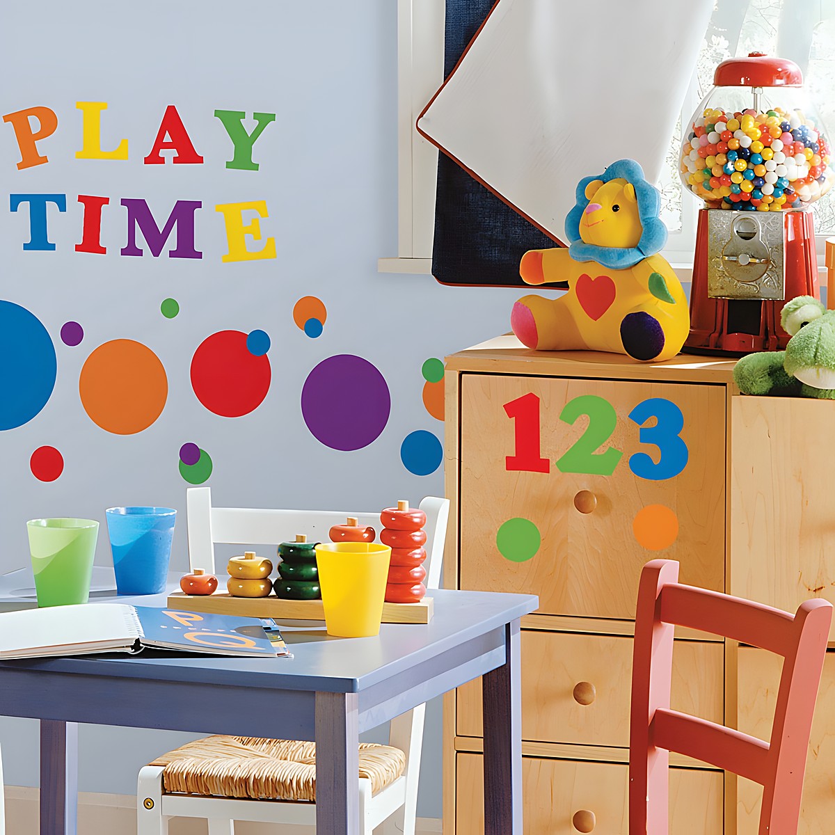RoomMates wall decal Colourful Numbers, colourful numbers and dots with Play Time lettering on a light blue children's room wall above a chest of drawers