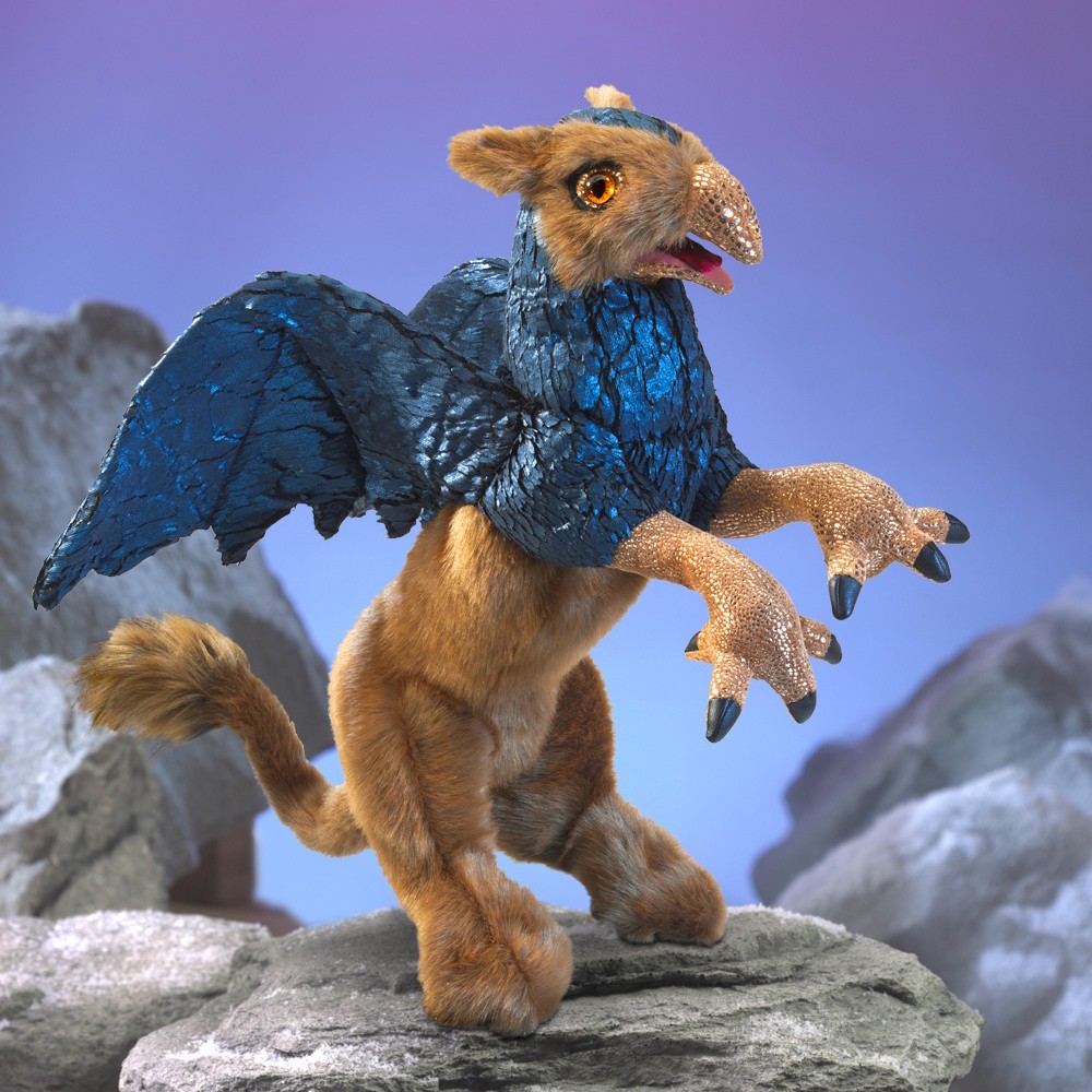 Folkmanis griffin hand puppet with golden fur, metallic blue wings and bird talons, rearing up on a rock