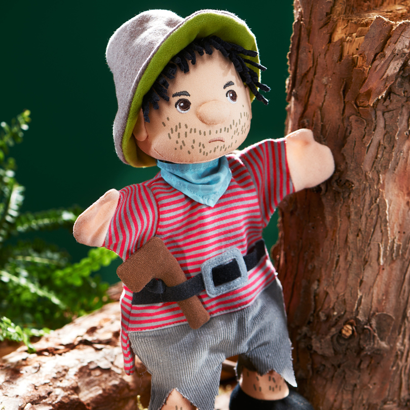 HABA baby hand puppet robber, lifestyle photo in the forest by a tree trunk