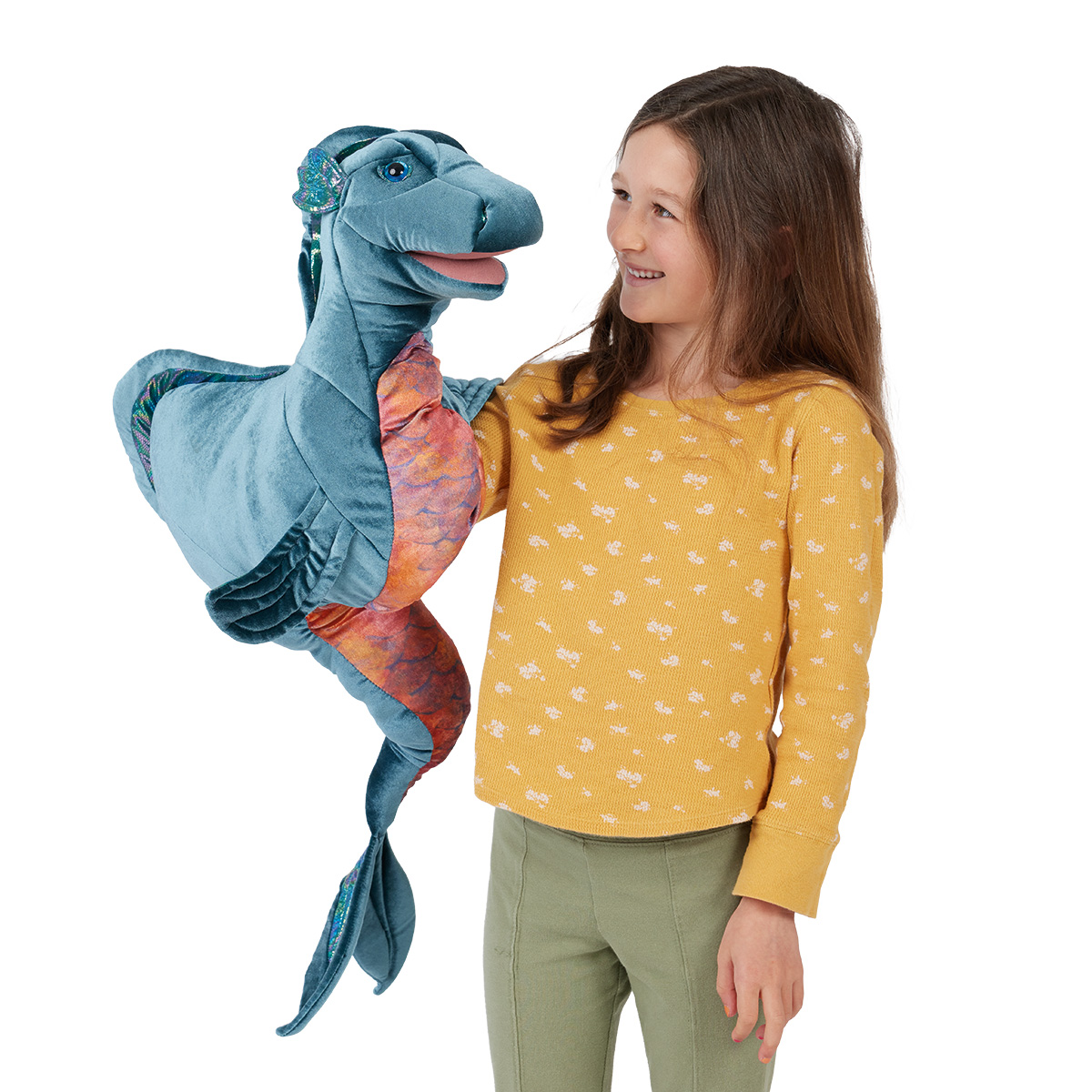 Girl operating the Folkmanis Loch Ness Monster hand puppet with a blue-and-orange scale pattern and glittery fins