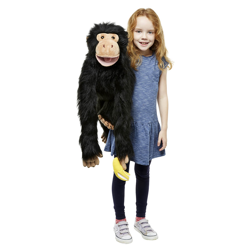 Girl holding the The Puppet Company giant chimpanzee hand puppet with a banana in her arms, usage example