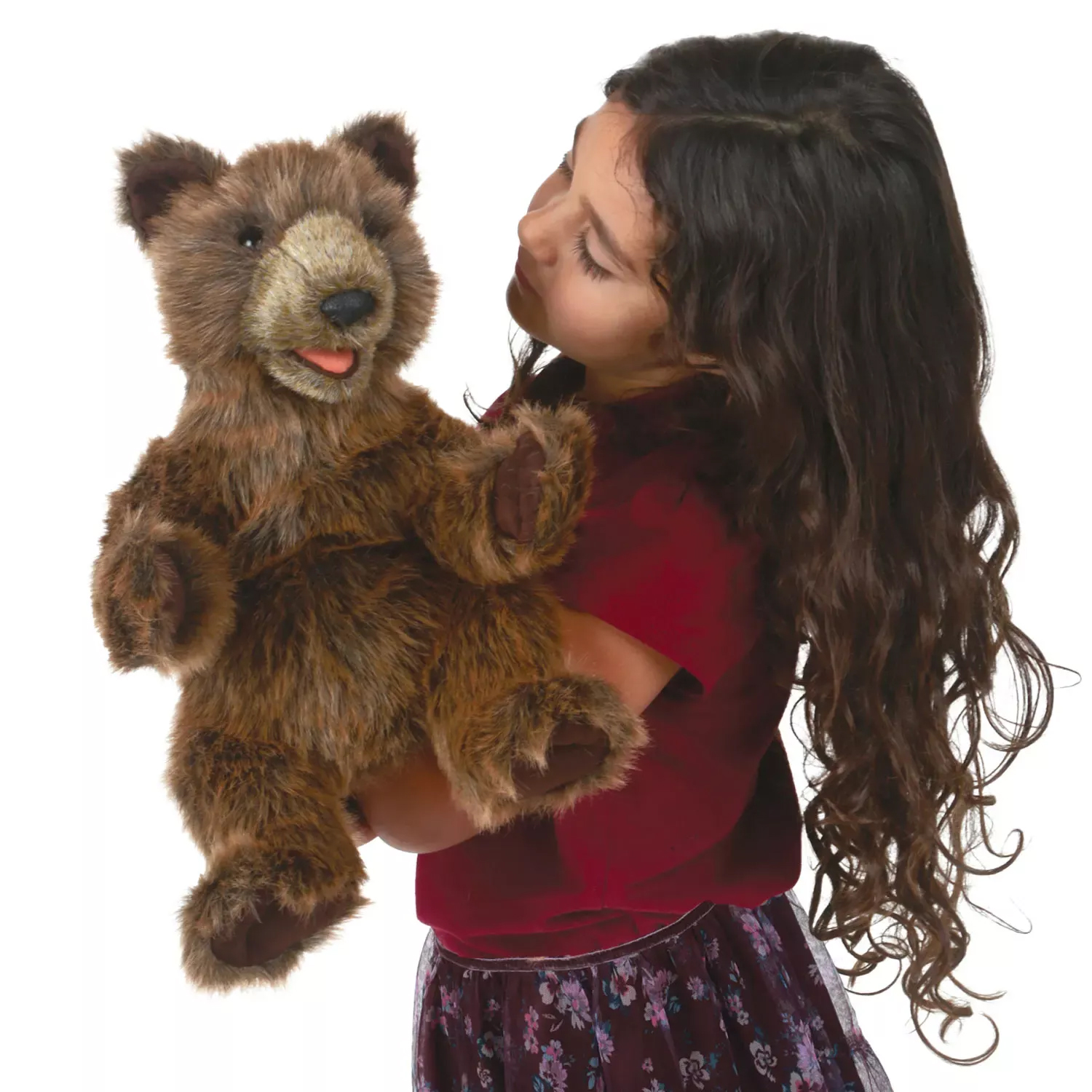 Girl holding up a Folkmanis brown bear cub hand puppet with plush fur and an open mouth