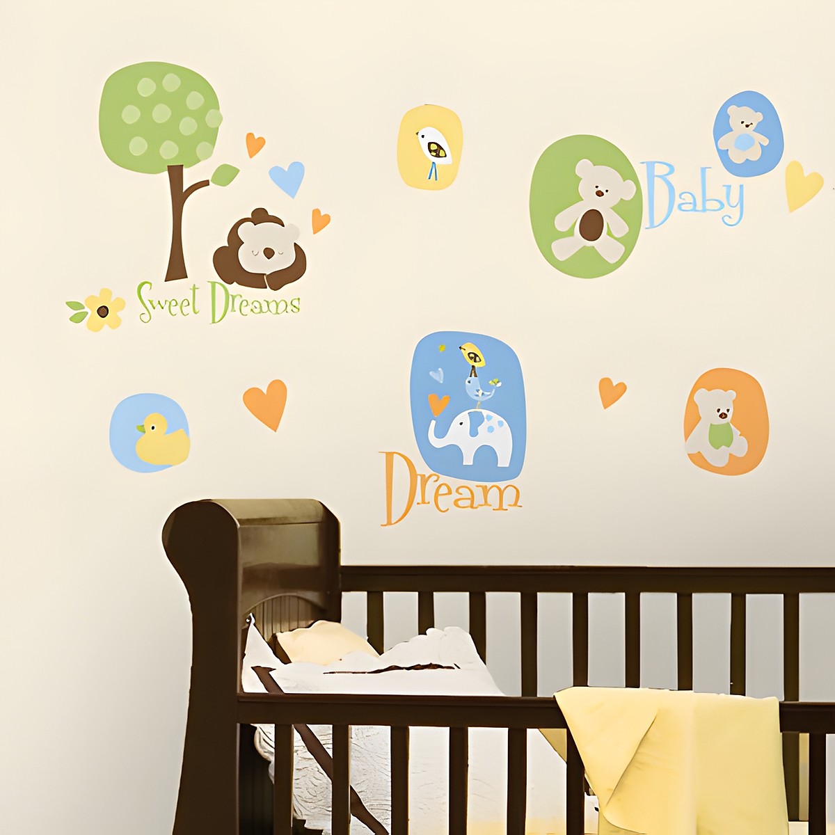 RoomMates wall decal Modern Baby, baby motifs with a bear, elephant, bird and tree plus Sweet Dreams, Baby and Dream lettering on a cream-coloured wall above a crib