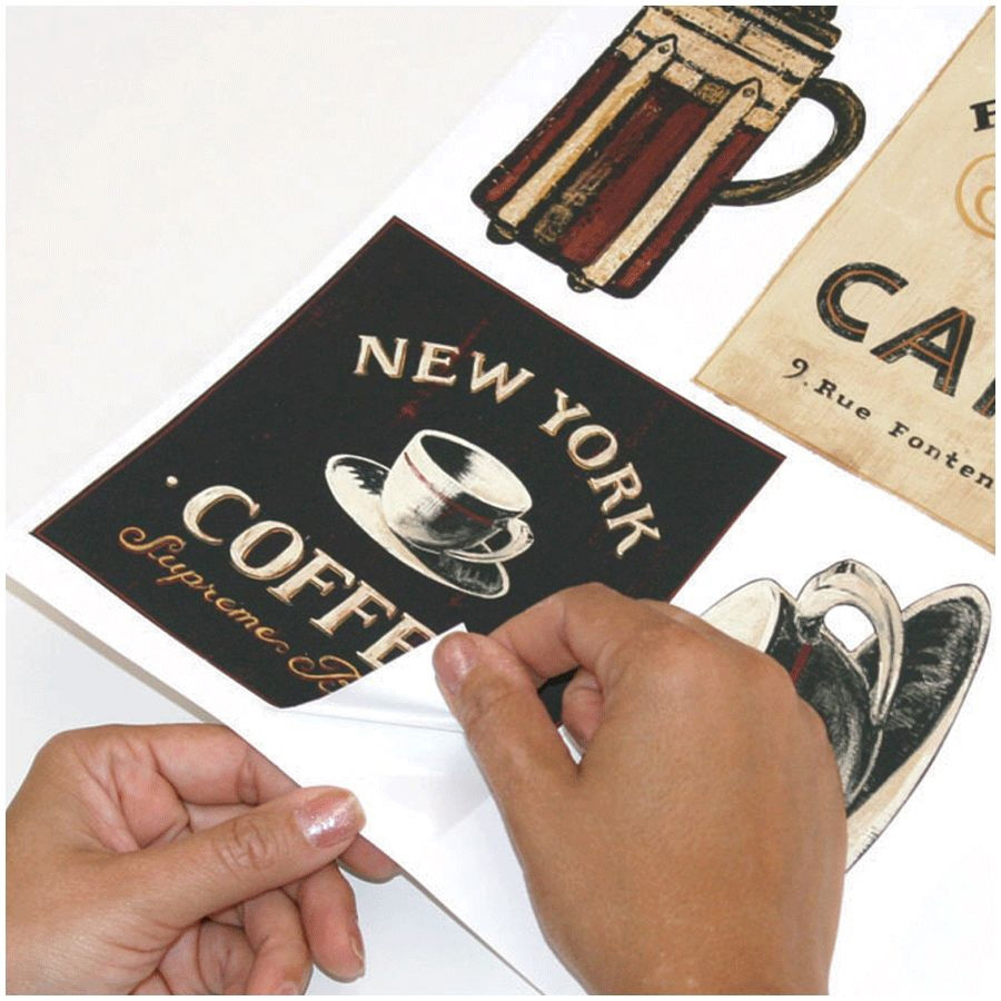 RoomMates wall decal Coffee House Peel & Stick, hands peeling a New York Coffee sign motif off the backing sheet, usage example