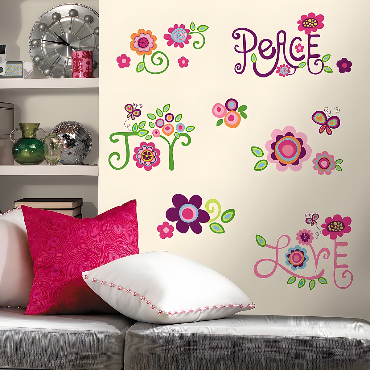 RoomMates wall decal Love Joy Peace, colourful flower and butterfly motifs with the words Peace, Joy and Love on a cream-coloured wall