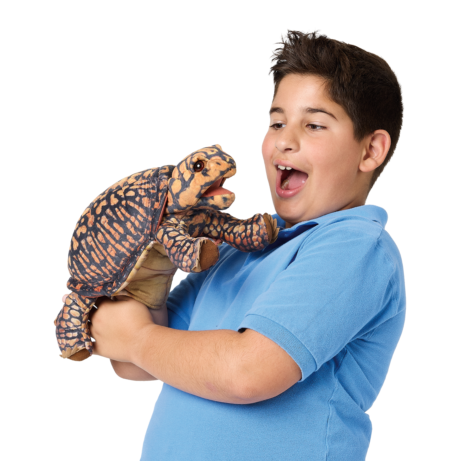 Boy holding up a Folkmanis box turtle hand puppet with an open mouth, dark orange-patterned shell, and clawed feet