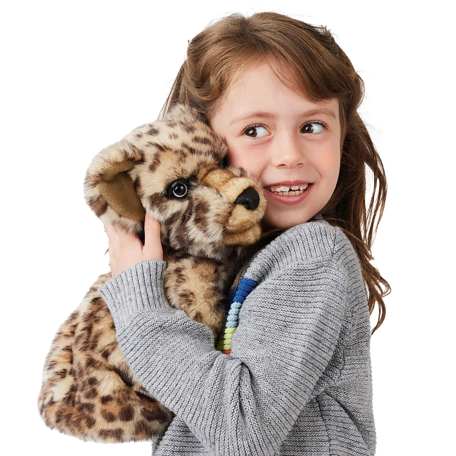 Girl pressing a Folkmanis leopard cub hand puppet with beige spotted fur and black nose against her cheek