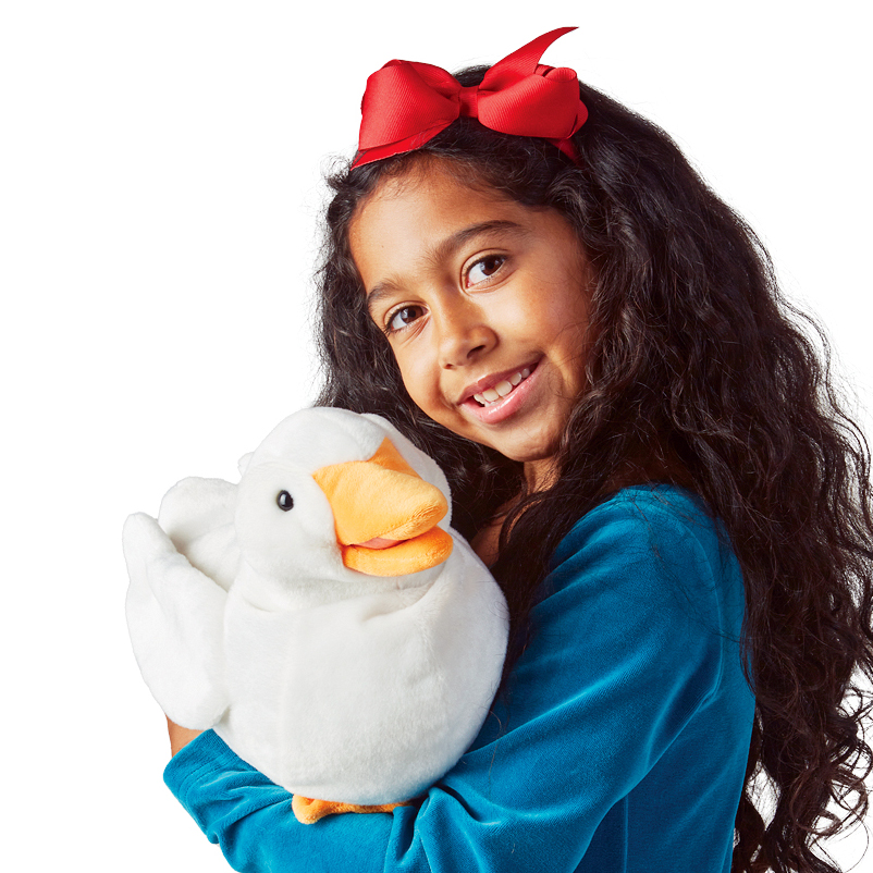 Girl in a teal top holding a white Folkmanis duck hand puppet with an orange beak in her arms