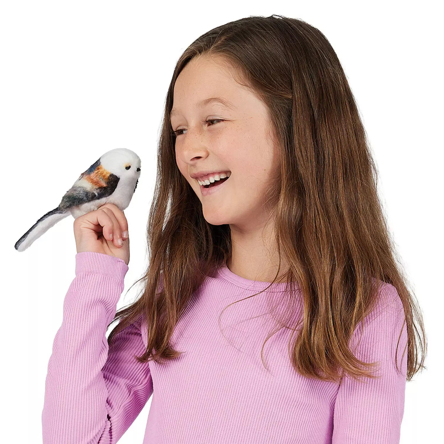 Girl holding a Folkmanis mini long-tailed tit finger puppet with a white head and grey-brown plumage on her finger