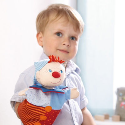 HABA baby hand puppet Kasper, lifestyle photo of a boy wearing the puppet