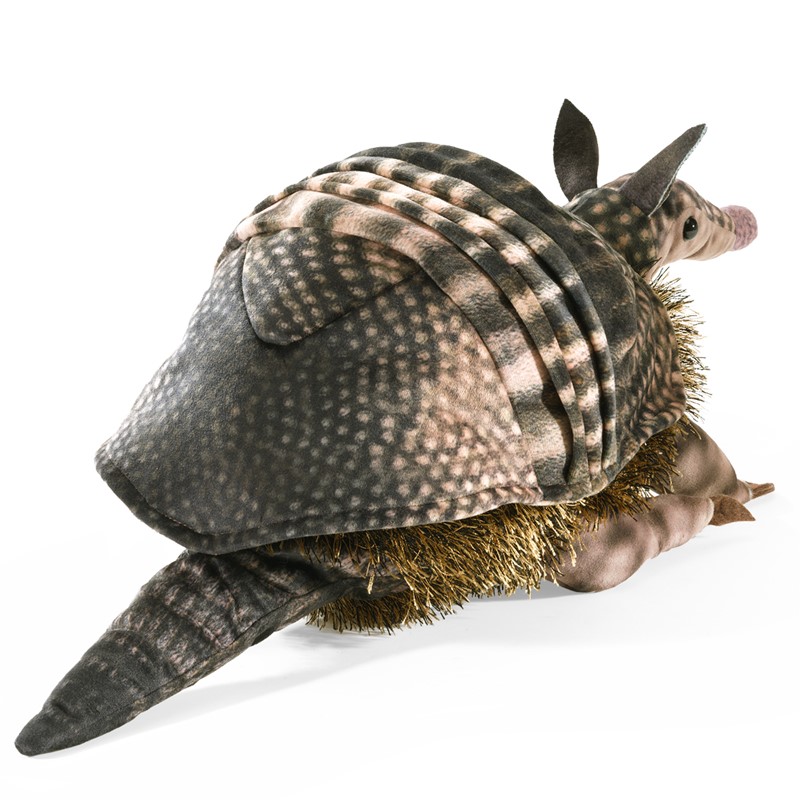 Folkmanis armadillo hand puppet with a detailed grey-pink textured shell and golden-brown belly fur, shown from a diagonal angle