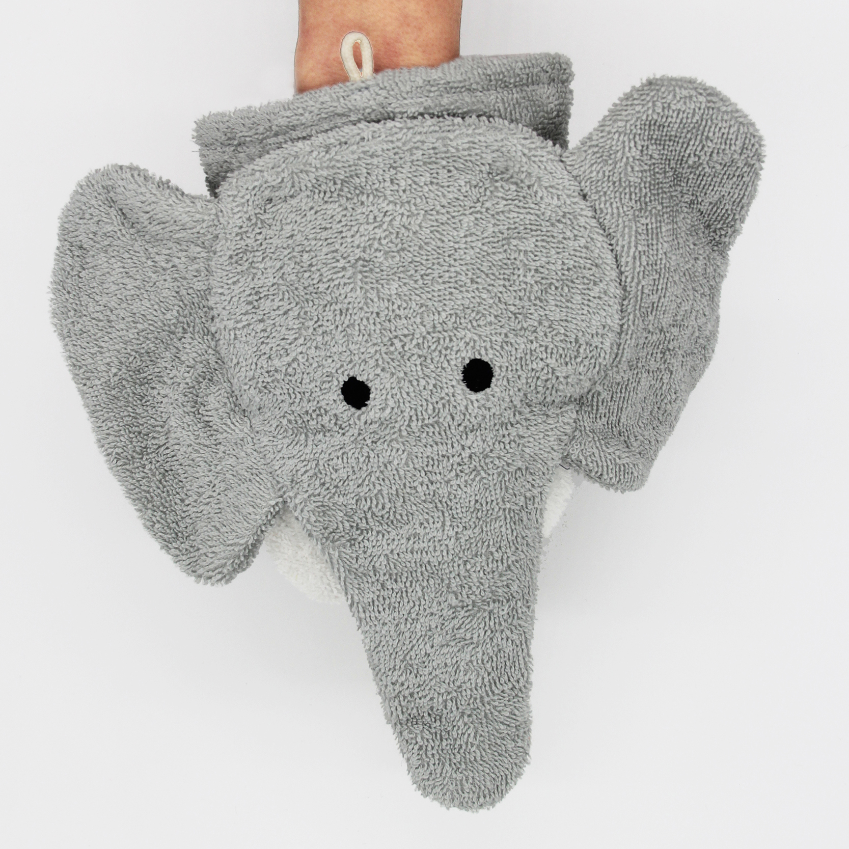 Fürnis organic washcloth elephant Ella worn as mitt on arm, front view with ears spread out