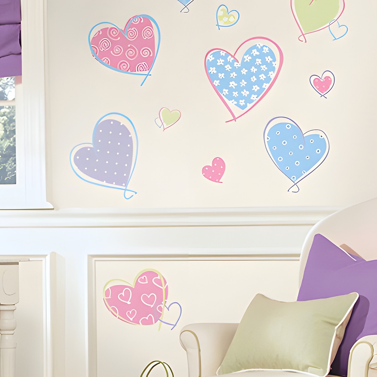 RoomMates wall decal Hearts, patterned heart motifs in pink, blue, purple and green on a cream-coloured wall above an armchair