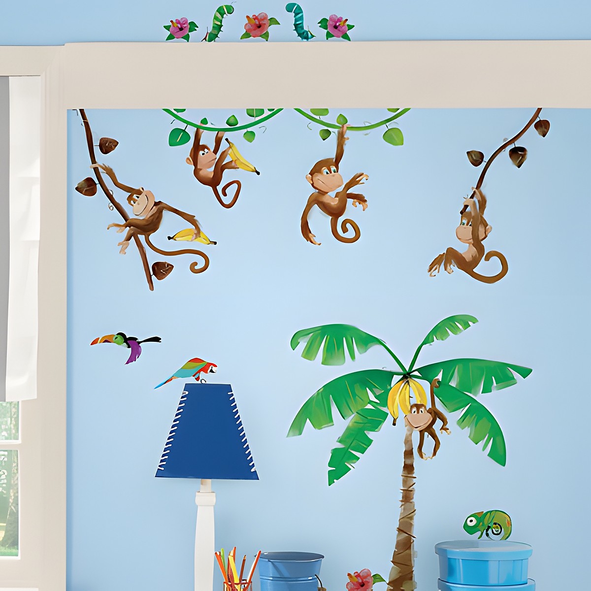 RoomMates wall decal Monkey's, monkeys on vines with bananas, a palm tree and birds on a light blue children's room wall above a shelf