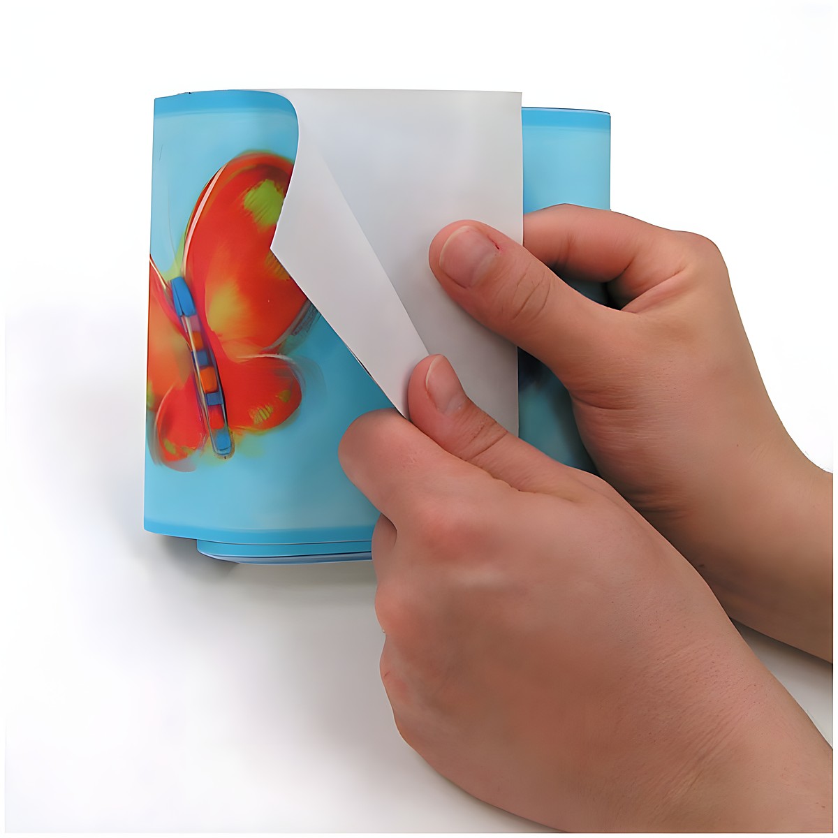RoomMates border Jelly Bugs, hands peeling the blue border strip with a butterfly motif off the backing paper, usage example