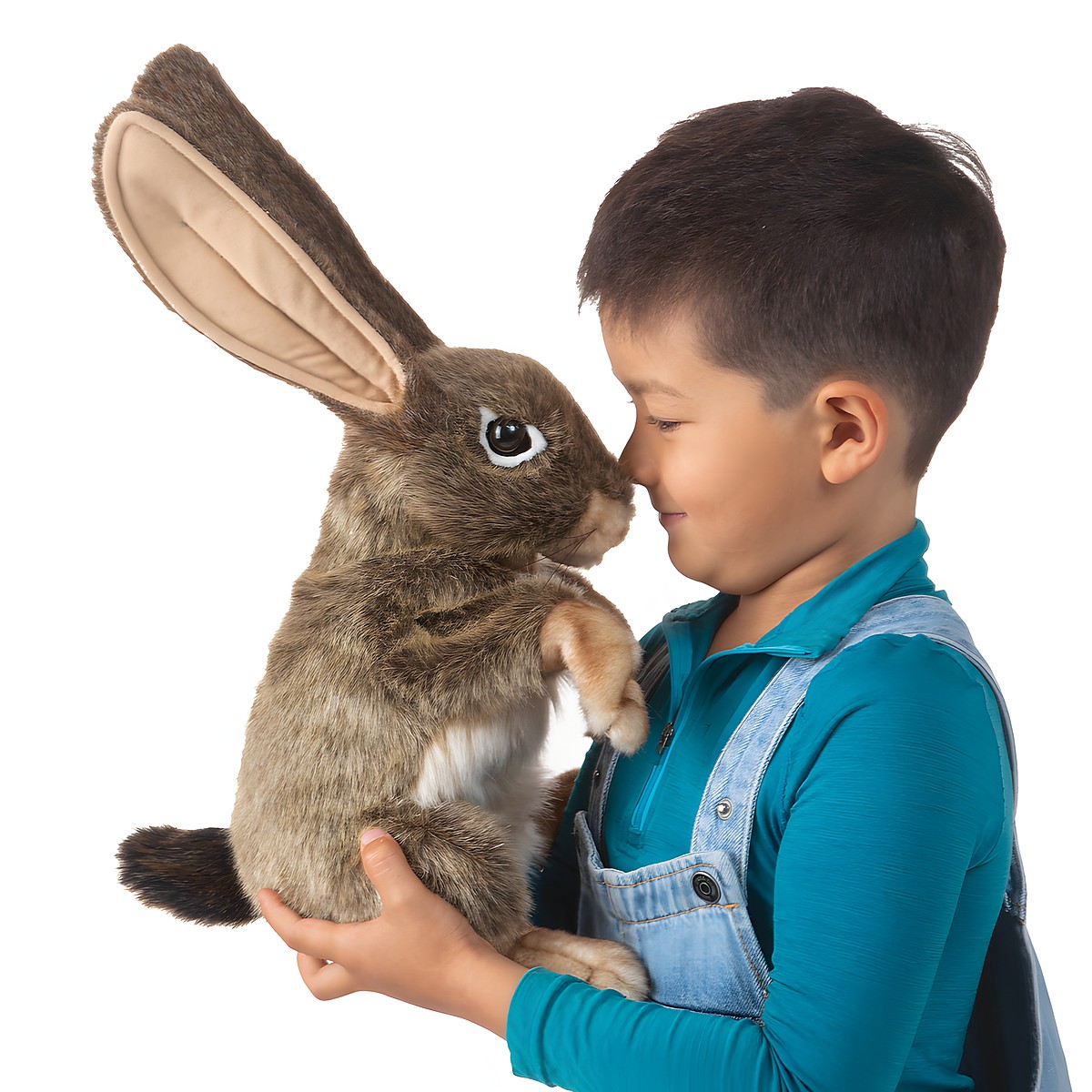 Folkmanis jack rabbit hand puppet with long upright ears, brown-grey fur and white belly, held by a child on a white background