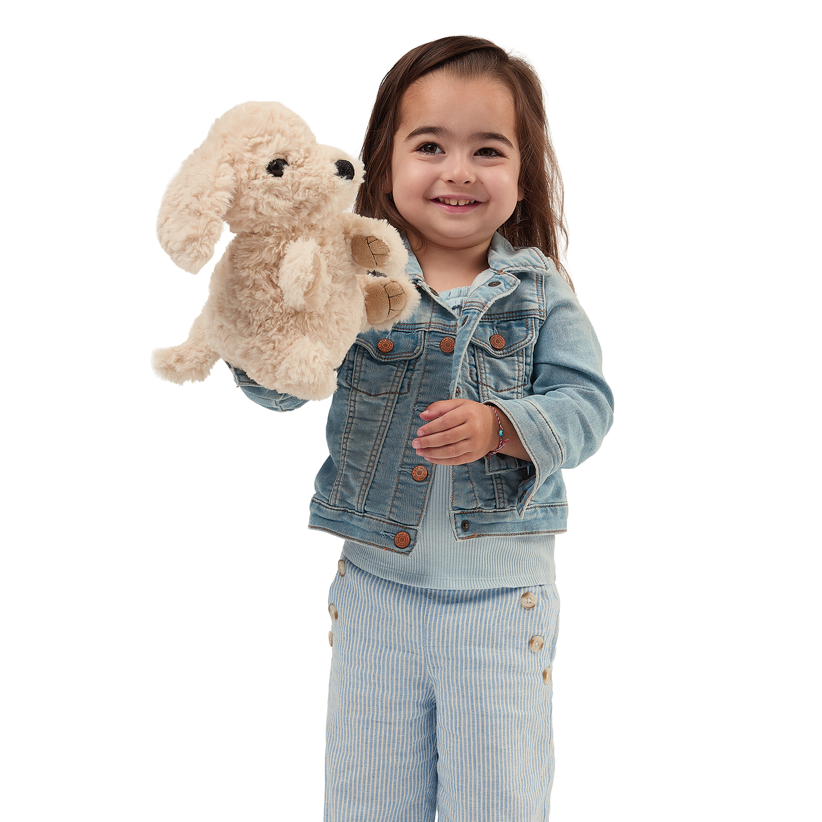 Folkmanis puppy hand puppet on a toddler's arm, shown side-on with its mouth closed.