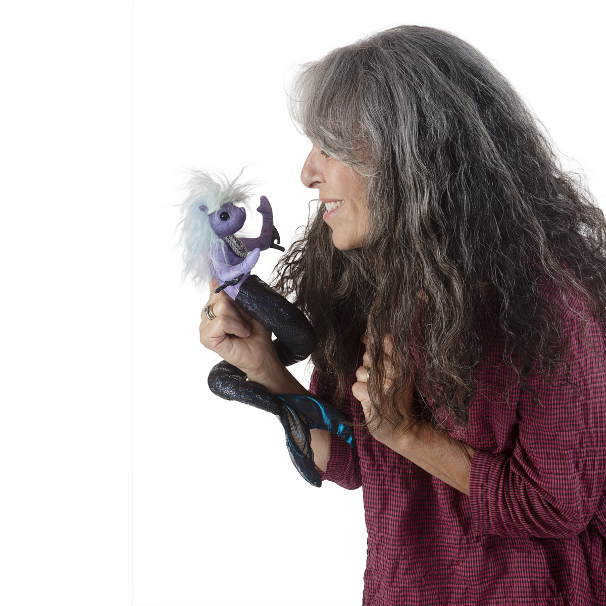 Woman operating the Folkmanis mini sea nymph finger puppet in purple with white hair and a dark scaly tail on her hand