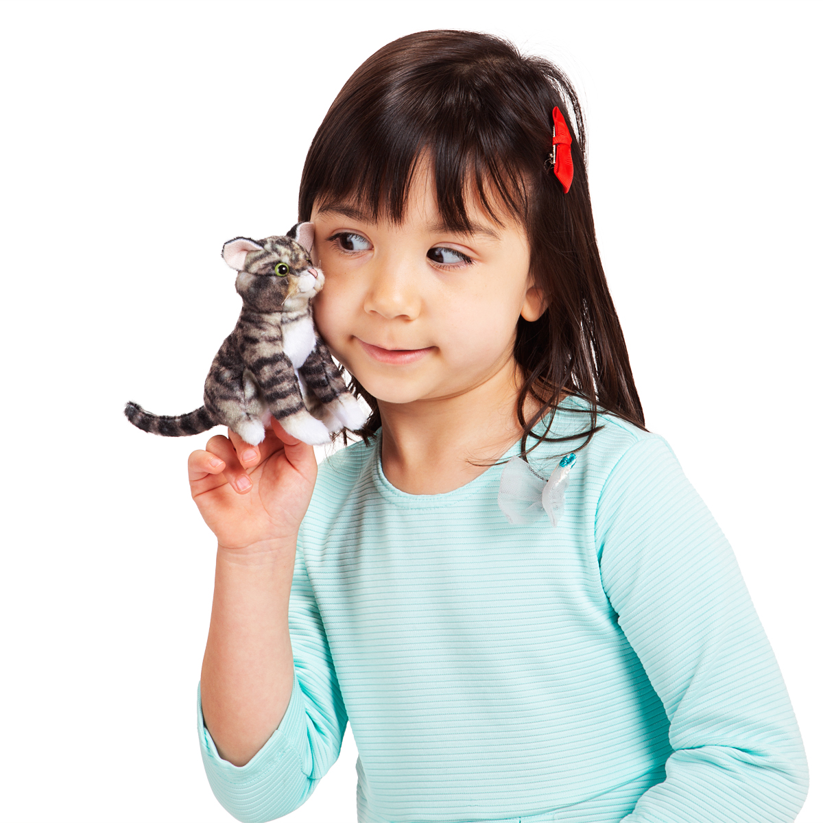 Girl holding the Folkmanis mini tabby kitten finger puppet on her index finger, grey-black striped plush kitten shown in side view