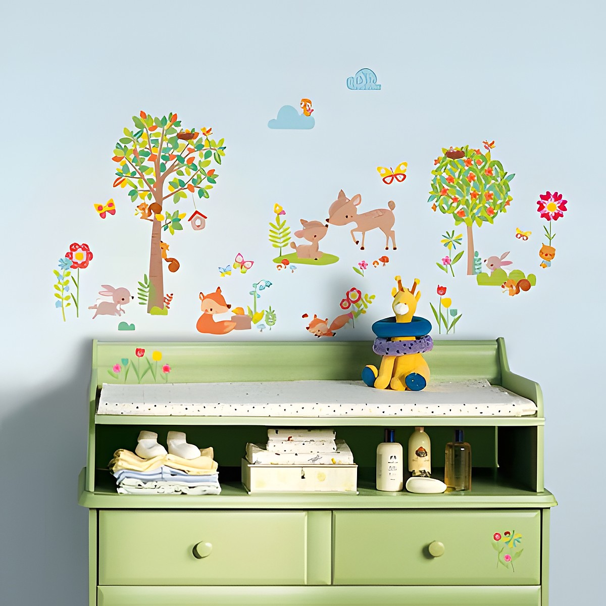 RoomMates wall decal Woodland Animals, woodland animals such as a deer, fox and squirrel with trees and flowers on a light blue children's room wall above a changing table