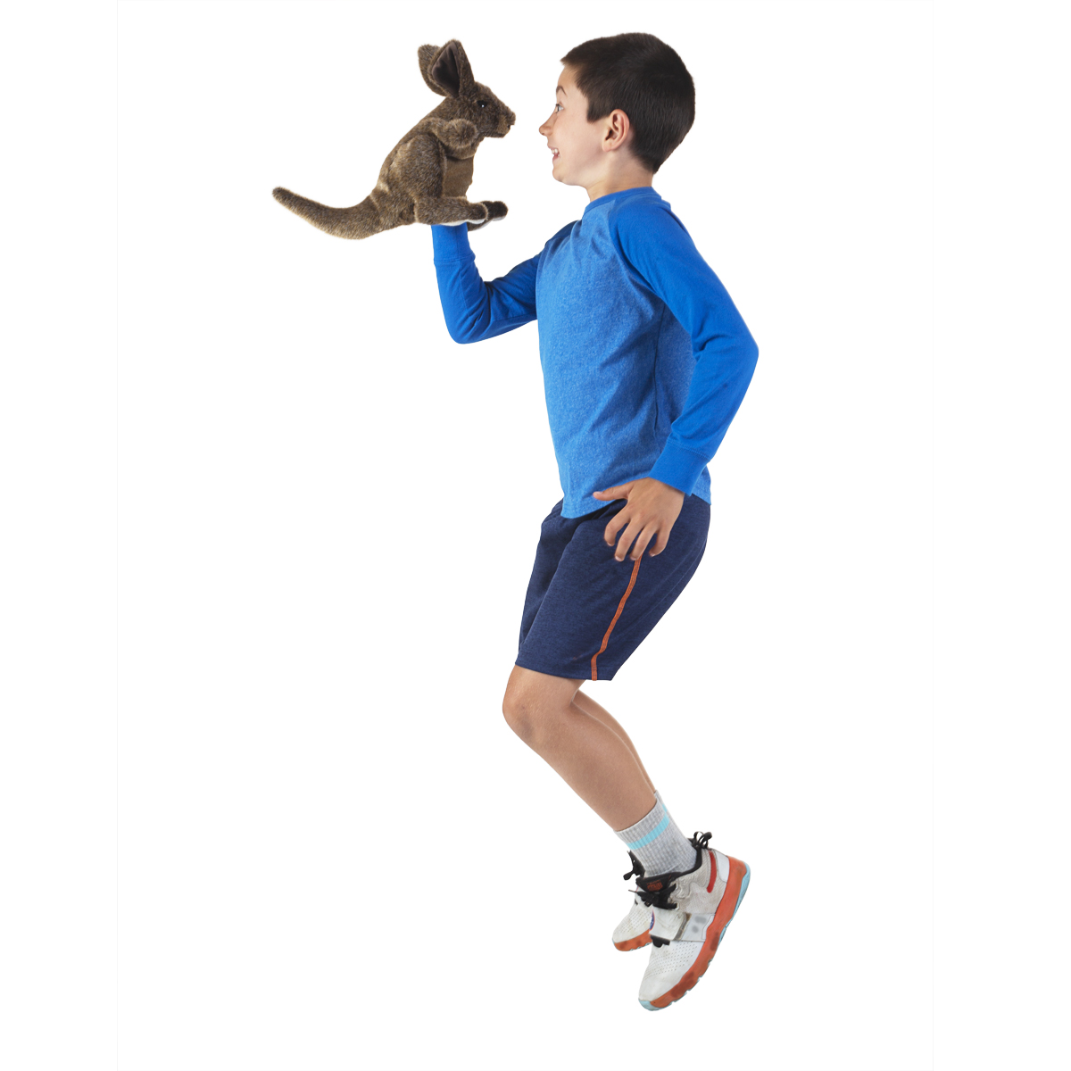 Boy jumping in the air, performing with the brown Folkmanis Small Kangaroo hand puppet on his outstretched hand