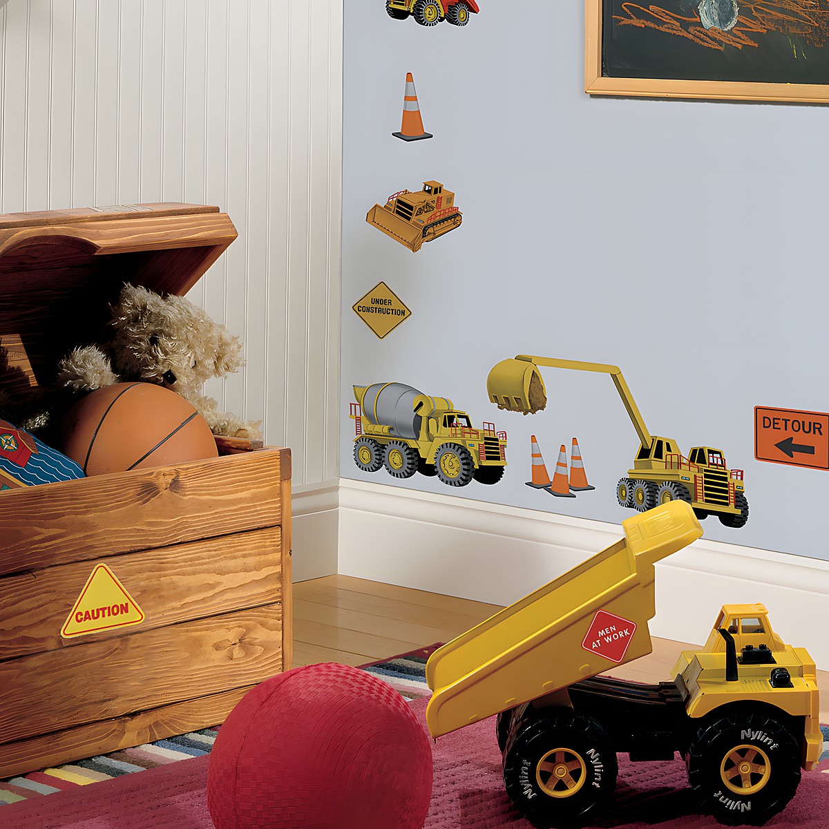 RoomMates wall decal Under Construction, construction vehicles and warning signs such as an excavator, cement mixer and detour sign on a light blue children's room wall