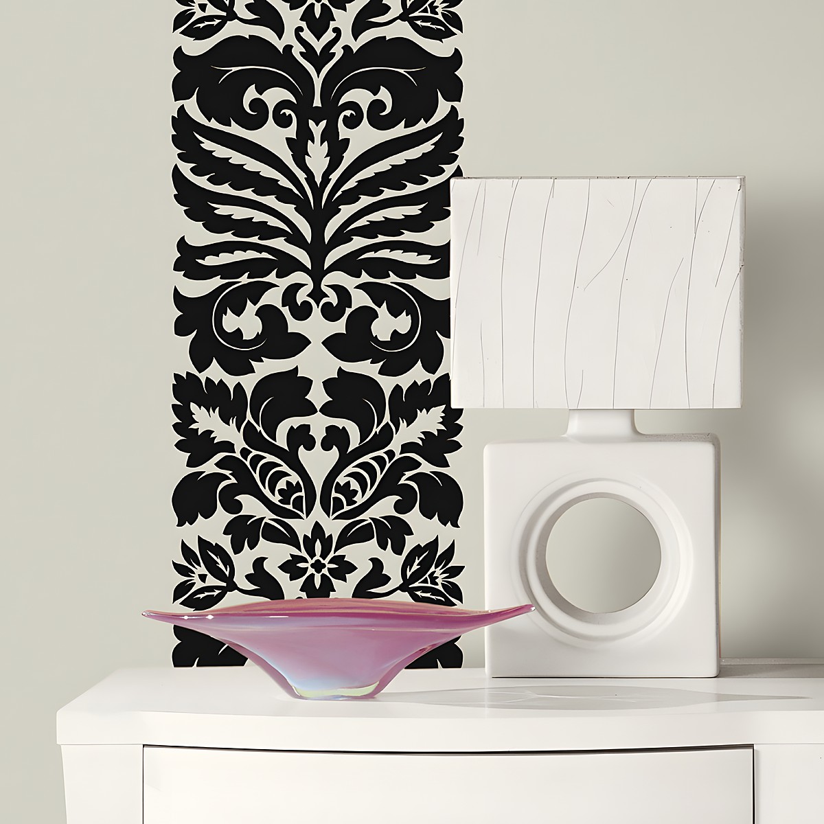 RoomMates wall decal Class A Peel & Stick, black damask ornament on a grey-green wall behind a white lamp