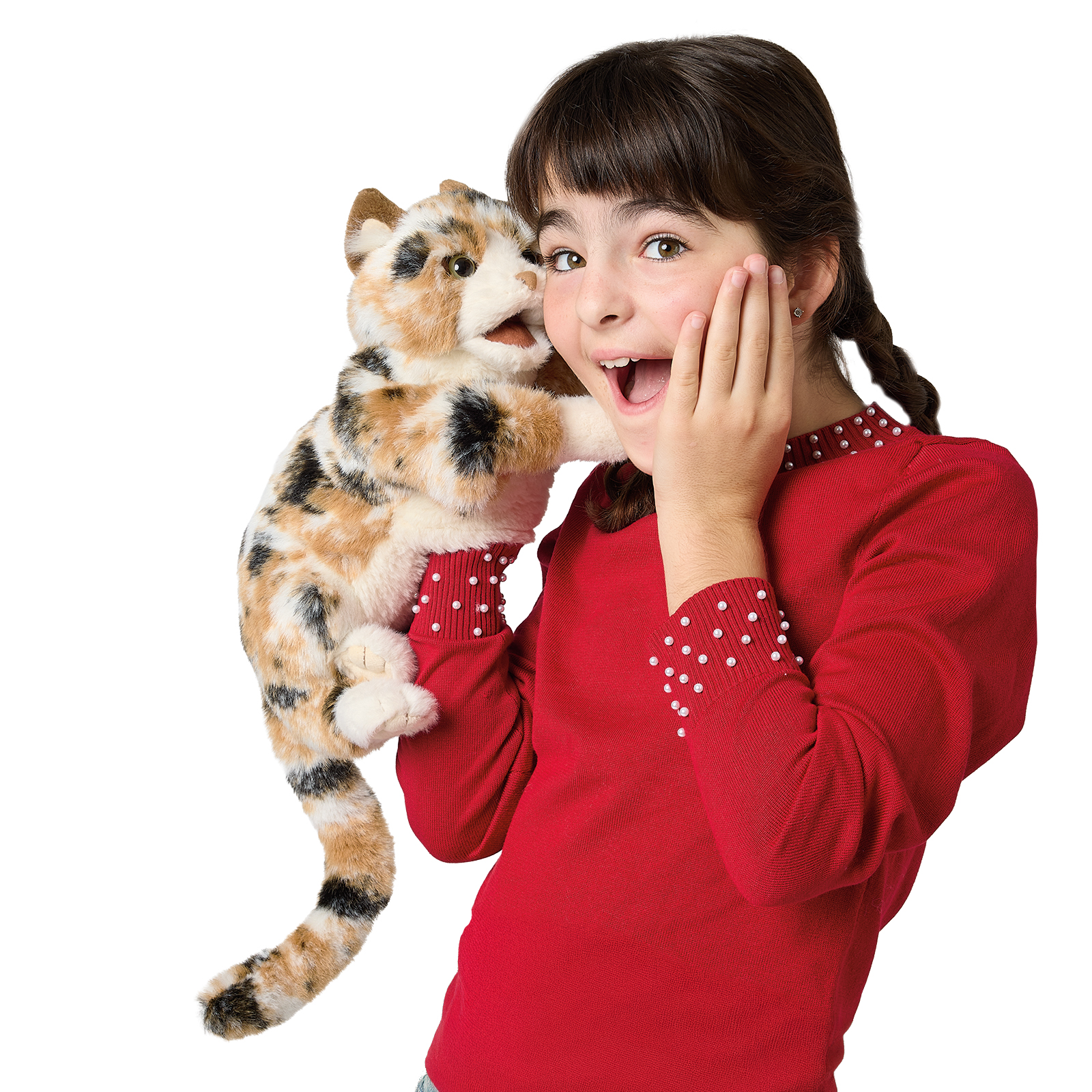 Girl holding a Folkmanis calico cat hand puppet with tricolour fur up to her ear, the cat's mouth open