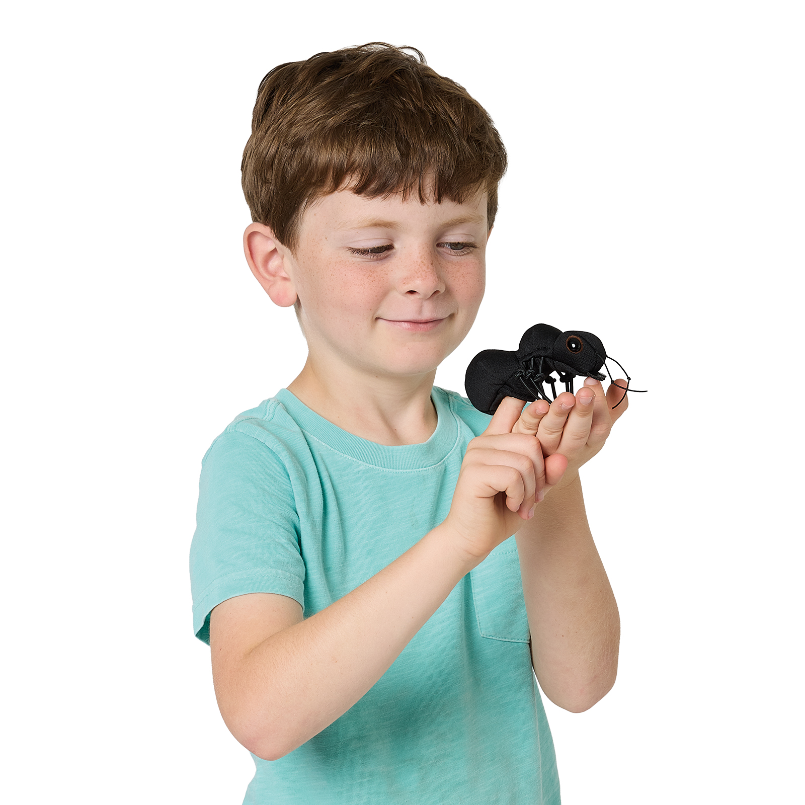 Boy smiling and looking at a black Folkmanis mini ant finger puppet on his fingers