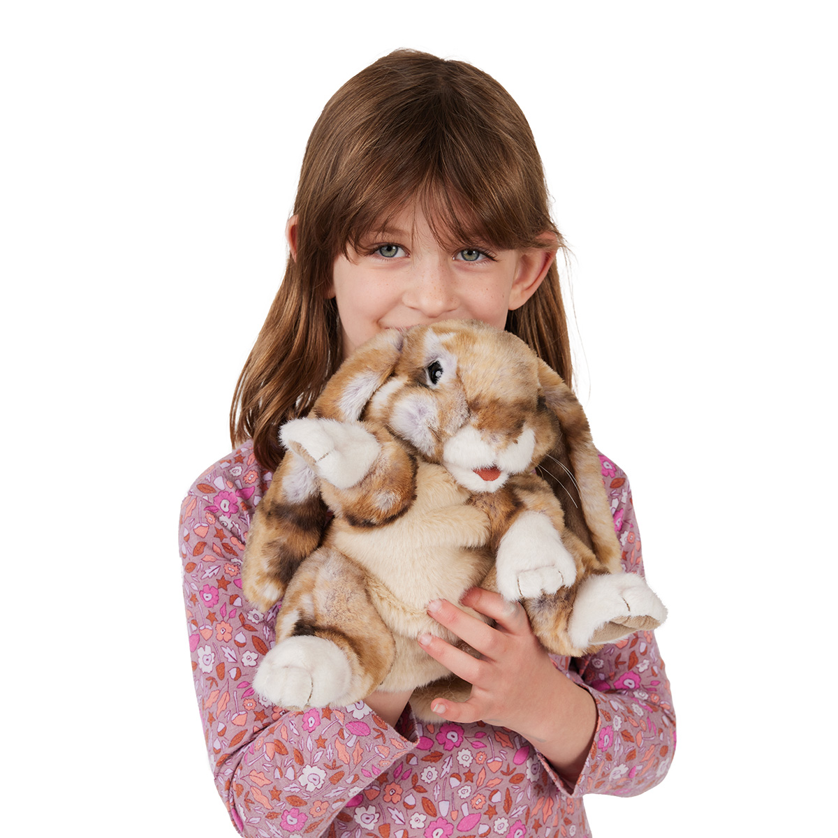 Girl holding a Folkmanis lop-eared rabbit hand puppet with a brown-beige spotted pattern and white paws close to her face