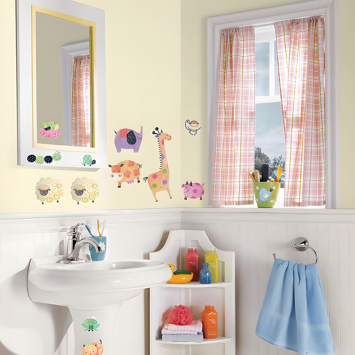 RoomMates wall decal Polka Dot Piggy, colourful farm animals such as an elephant, giraffe and sheep on a yellow bathroom wall next to a window
