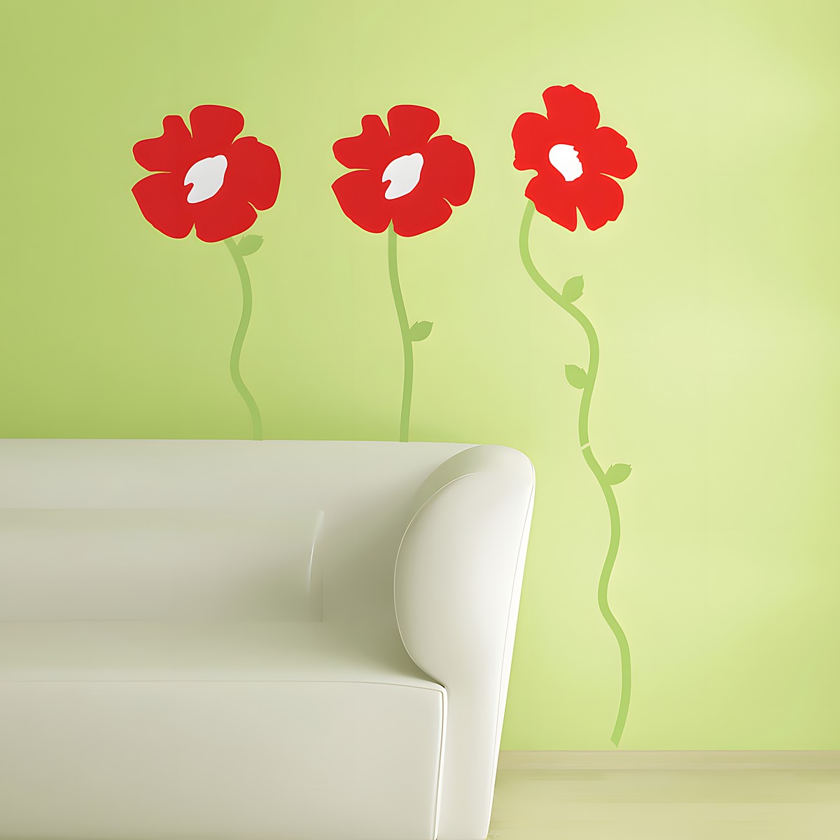 RoomMates wall decal Poppies Peel & Stick, red poppy flowers with green stems on a light green wall behind a sofa